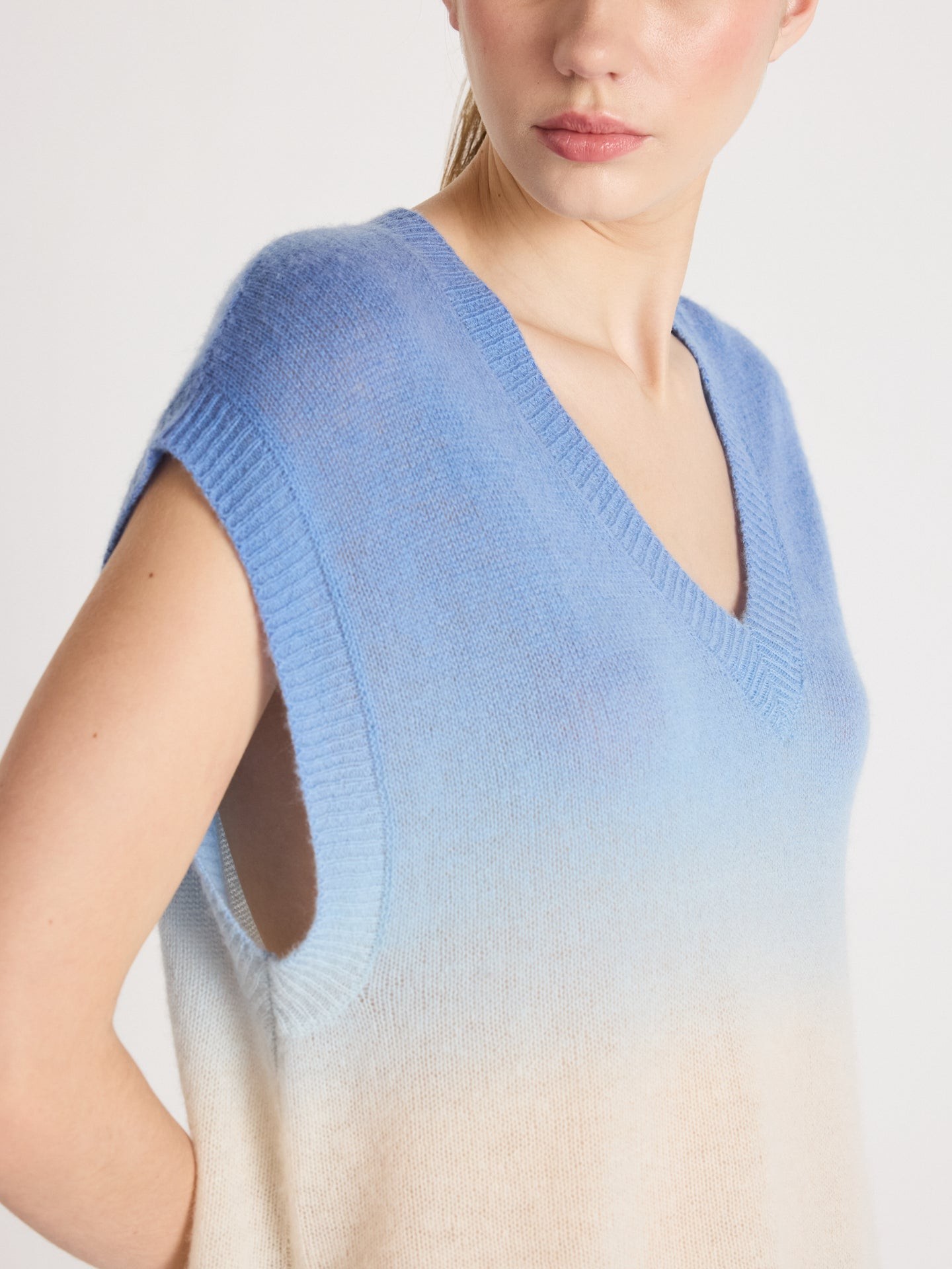 Half-body studio shot of gradient sky blue off-white 12GG lightweight Washi yarn V-neck sleeveless knit vest, sheer cool Japanese paper fiber summer layering women knit top