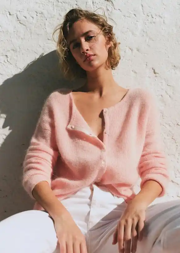 Model wearing a soft pink mohair blend cardigan, showcasing the lightweight, fuzzy texture and relaxed fit of premium knitwear from our OEM sweater factory.