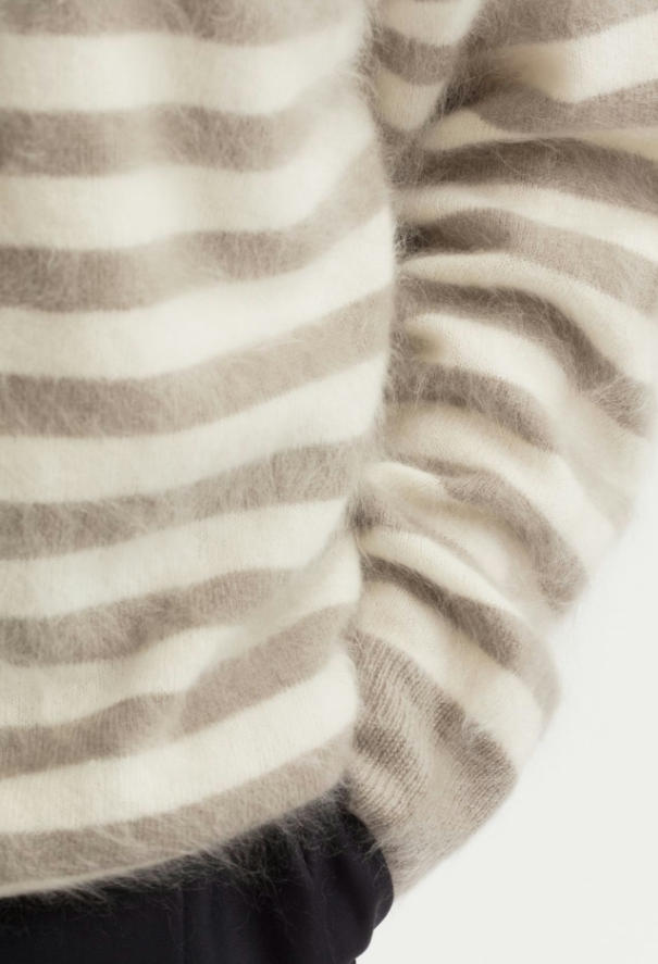 Close-up texture shot of brushed fuzzy cashmere striped crew neck sweater, natural beige grey horizontal stripe fuzzy knit detail, soft halo fleece cashmere pullover fabric closeup