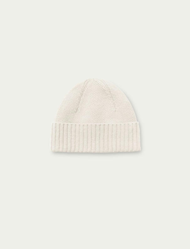 Minimal flat lay product photo of off-white cashmere silk ribbed knit beanie, solid tone luxury warm winter cashmere silk blend skull cap with folded rib cuff