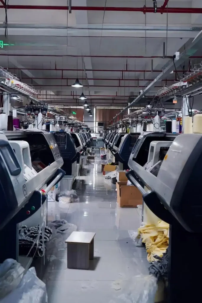 Seamstress operating linking machine in knitwear factory, custom knitwear for influencers and creator brands